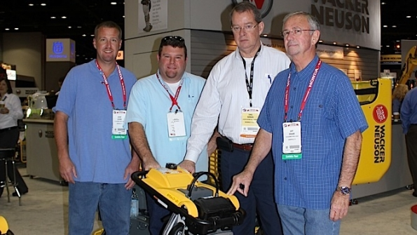 Jeremy Cousins Mike Cousin and Gary Branam of BampM Equipment Rentals receive a new rammer from Wacker Neuson at the Rental Show Second from right is Christopher Barnard president and CEO of Wacker Neuson Corp