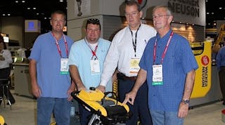 Jeremy Cousins, Mike Cousin, and Gary Branam of B&amp;M Equipment Rentals receive a new rammer from Wacker Neuson at the Rental Show. Second from right is Christopher Barnard, president and CEO of Wacker Neuson Corp.