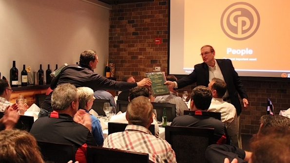 Chicago Pneumatic executive vice president John Vogel hands out an award at the companyrsquos sales meeting at ARA
