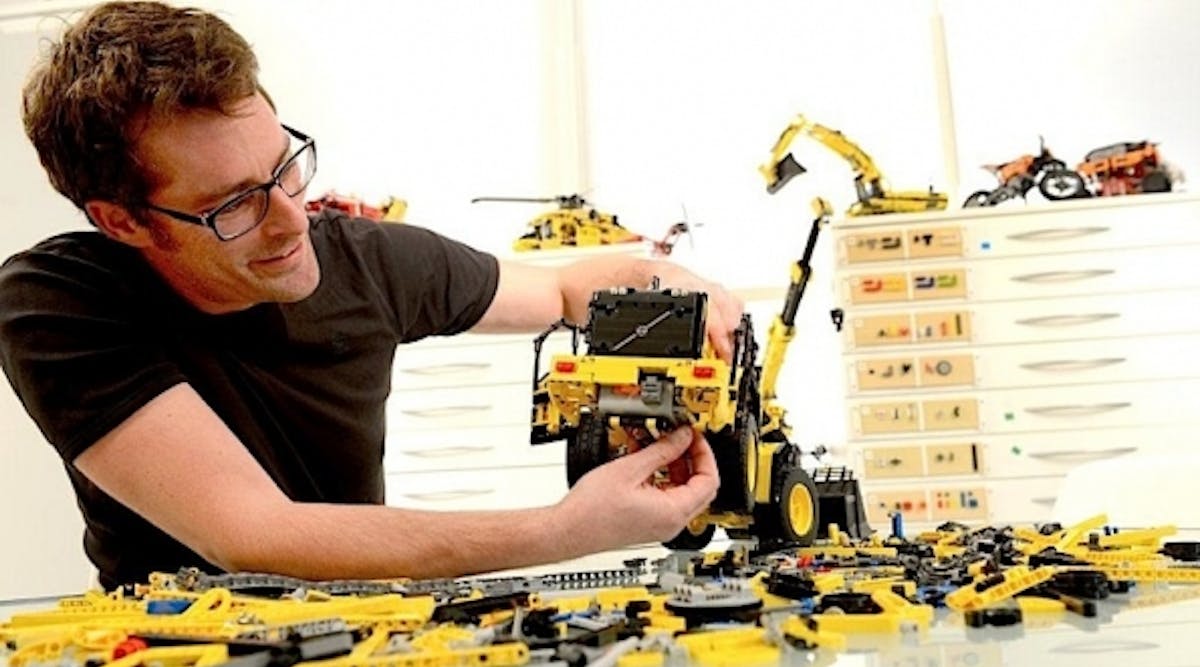 LEGO Technic design manager, Jeppe Juul Jensen, assembles a model Volvo L350F wheel loader.