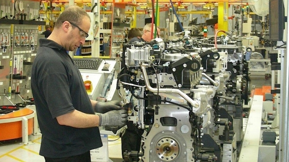 A worker prepares an engine for production at Perkinsrsquo Peterborough UK plant Photo by Michael Roth RER