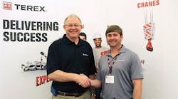 From left: Jim Strobush, regional sales manager for Terex Cranes, shakes on the deal with Jeremy Landry, project manager for Deep South Crane &amp; Rigging.