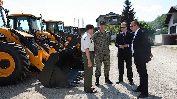 Preparing to hand over the backhoe from left Lt Col Rob Tomlinson of the British Embassy General Sakib Foric of the Bosnian Army Sinisa Tomasic regional director of TERRA South and Tarik Kamenjasevic managing director of Terra BiH