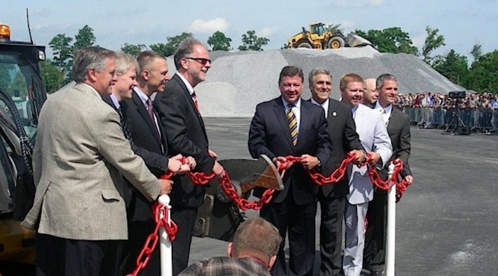 Volvo CE officials and political dignitaries participate in a unique form of ribbon cutting. (Photo by Michael Roth, RER)