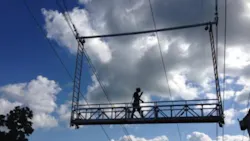 Spider built a 30foot swingstage equipped with custom rollers that enabled the platform to travel along the conductor with multitier suspended scaffold ladders added to both ends of the platforms and suspended from rigging trolleys A unique fallprotection system was included Spider built a 30foot swingstage equipped with custom rollers that enabled the platform to travel along the conductor with multitier suspended scaffold ladders added to both ends of the platforms and suspended from rigging trolleys A unique fallprotection system was included