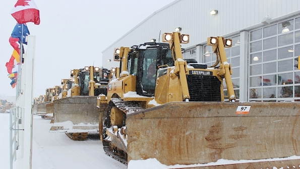 Earthmoving machinery crosses the stage at Edmonton auction