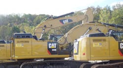 Caterpillar equipment sits at a rental yard. Caterpillar is laying off 200 production workers because of soft mining demand.