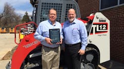 Takeuchi U.S. president Clay Eubanks, right, presents Top Volume Dealer of the Year Award for 2014 to Folcomer Equipment president Dave Folcomer.