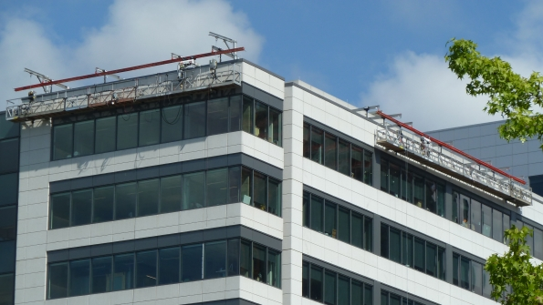 A suspended platform used in glass installation by Spider a division of SafeWorks