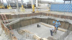 Workers in a trench shored by National Trench Safety at a petrochemical plant Workers in a trench shored by National Trench Safety at a petrochemical plant