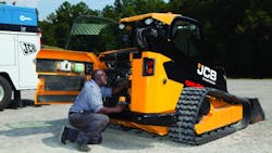 A JCB Master Technician works on equipment A JCB Master Technician works on equipment