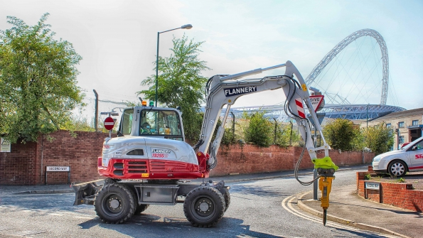 An Atlas Copco hydraulic breaker mounted on a Takeuchi compact air compressor
