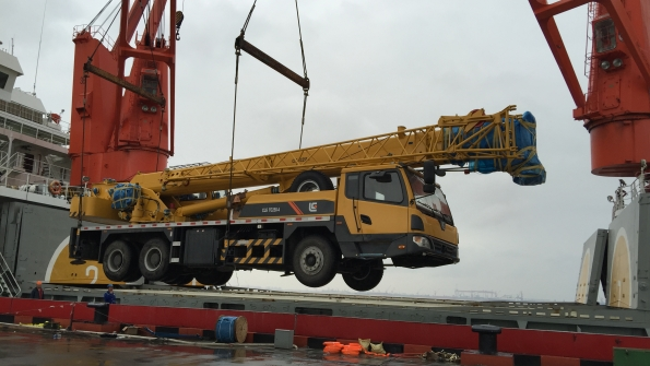 The LiuGong TC2504 crane is loaded onto a ship in Shanghai bound for Antarctica for loading and unloading cargo truck hoisting and house repair work at a Chinese research facility