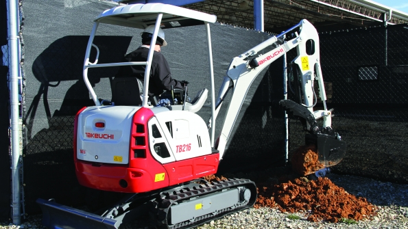 A Takeuchi TB216 compact excavator at work