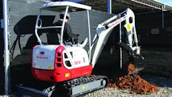 A Takeuchi TB216 compact excavator at work A Takeuchi TB216 compact excavator at work