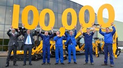 JCB staff celebrates the milestone. From left: compact products managing director Buda Atwal; compact products general manger Ian Gillott; assembly technician Paul Mellor; paint sprayer Dave Thacker; maintenance fitter Mark Bentley; fitter Gary Ratcliffe and welder Melvin Sims.