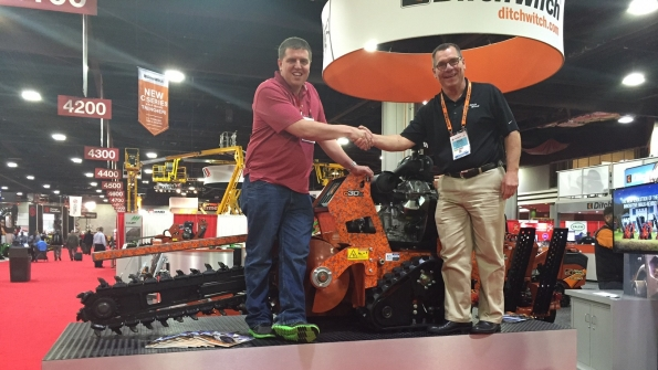 Curtis Gillman of Gillman Home Center in Batesville Ind wins a brand new C30X walkbehind trencher At right is Ditch Witch vice president of sales and marketing Shan Kirtley