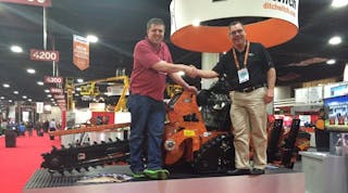 Curtis Gillman of Gillman Home Center in Batesville, Ind., wins a brand new C30X walk-behind trencher. At right is Ditch Witch vice president of sales and marketing Shan Kirtley.