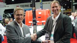 RER&apos;s James Carahalios, left, presents Generac&apos;s vice president of sales Mark Hanson, right, wth RER&apos;s Innovative Product Award in the light tower category at the recent Rental Show.