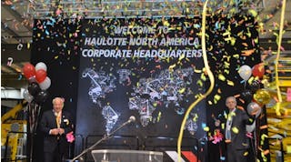 Virginia Beach Mayor Williams Sessoms, left, and Haulotte chief operating officer Alexandre Saubot, celebrate the Grand Opening of Haulotte&rsquo;s new North American headquarters.