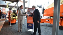 Riwal&apos;s Norty Turner, left, seals the deal with JLG president Frank Nerenhausen, at Bauma.