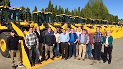 PacWest Machinery staff along with a row of wheel loaders. PacWest will serve as an SDLG dealer and a distribution facility for the West Coast.