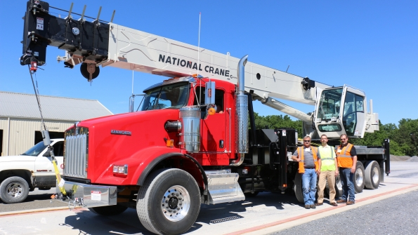 From left Rick Mueller president of Crane Services Justin Pilgrim global product director for boom trucks amp carry deck cranes at Manitowoc and Leroy Kane sales specialist at Dawes Rigging amp Crane Rental with the new NBT50 crane