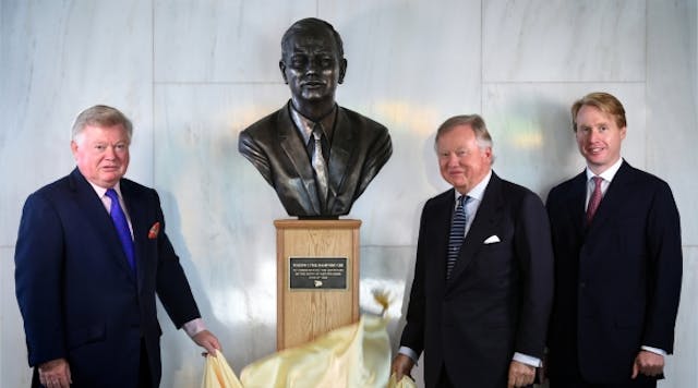 Mark Bamford, left, and Lord Anthony Bamford, sons of JCB founder Joseph Cyril Bamford, and Jo Bamford, grandson, unveil bronze bust of &apos;Mr. JCB&apos; on the 100th anniversary of his birth.