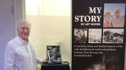 Art Moore promotes his autobiography at Snorkel&apos;s booth at last year&apos;s Rental Show.