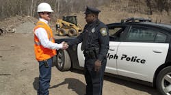 A contractor thanks a police officer for helping to recover stolen equipment.