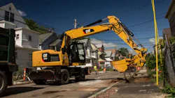 A Caterpillar wheeled excavator at work A Caterpillar wheeled excavator at work