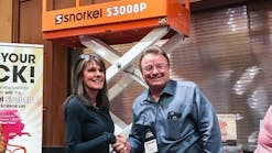 Lynne Domey of Eastern Oregon Sales &amp; Rentals takes home a Snorkel S3008P scissorlift and is congratulated by Snorkel owner Don Ahern.