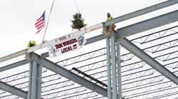 Crews place the final beam in the structure of Lincoln Electric Co.&apos;s Welding Technology Center.