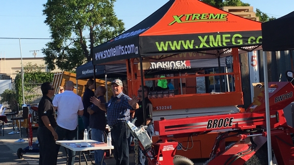 Jim Grasse of Broce Brooms talks about equipment with a rental company visitor Broce Snorkel Makinex and others exhibited at the ARACRA chapter meeting at American Pneumatic Tools39 facility in Santa Ana