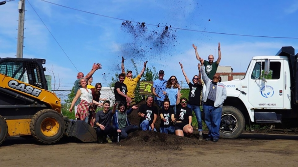 Volunteers toss soil in the air to celebrate the planting of 514 foodgrowing gardens The initiative promotes a sustainable food system by building communities of people who grow their own food and provides educational programs and urban agricultural projects