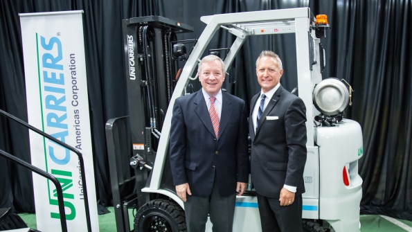 US Senator Dick Durbin at left visits UniCarriers America in Marengo Ill in recognition of its role in creating jobs and manufacturing opportunities At right is UniCarriers president James Radous III