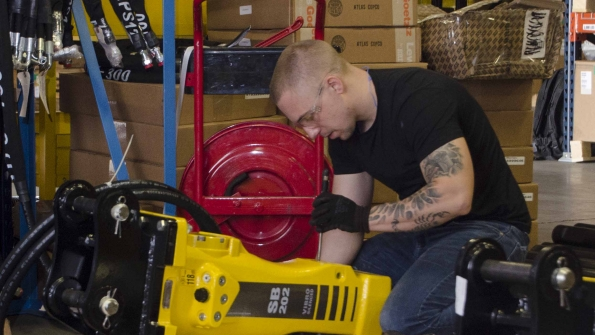 An Atlas Copco worker at the Hydraulic Attachment Competency Center