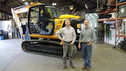 From left Norlift JCB sales manager Nate Jarvis and owner Jay Jarvis with the first sold JCB machine a JS145 excavator From left Norlift JCB sales manager Nate Jarvis and owner Jay Jarvis with the first sold JCB machine a JS145 excavator