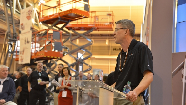 Skyjack president Brad Boehler wearing beads and speaking the last time The Rental Show was in New Orleans