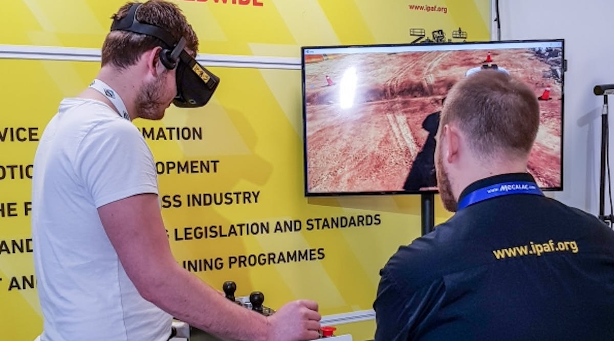 A visitor to the IPAF stand tries out the virtual reality training simulator.
