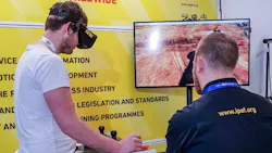 A visitor to the IPAF stand tries out the virtual reality training simulator