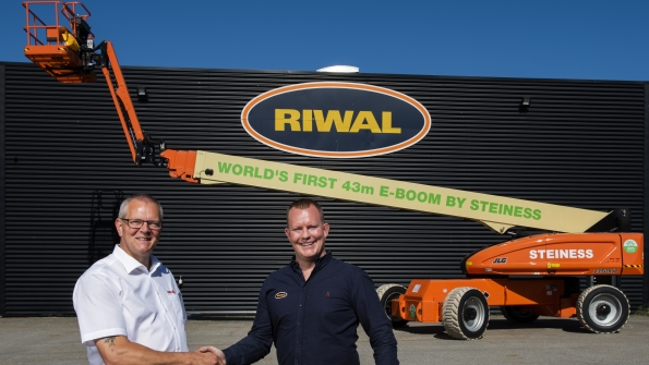 Poul Steiness left receiving his brand new 100percent electric boomlift handed over by Riwal equipment sales manager Nordics Jesper Becker