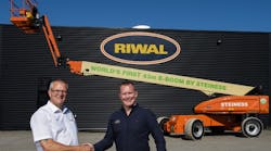 Poul Steiness, left, receiving his brand new 100-percent electric boomlift, handed over by Riwal equipment sales manager Nordics, Jesper Becker.