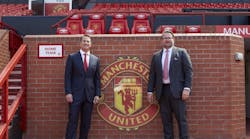 David Kohler, president and CEO of Kohler Co. (left), with Richard Arnold, group managing director of Manchester United, with the Manchester United logo.