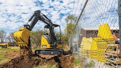 A John Deere compact excavator at work A John Deere compact excavator at work