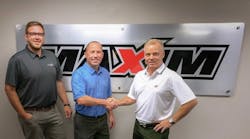 Bob Krause, center, regional business manager, Tadano America, shakes hands with Frank Bardonaro, chief operating officer, Maxim Crane Works, as the crane rental giant invests in 15 large Tadano rough terrain cranes to serve customers in the petrochemical industry. At left is Kevin Schultz, vice president, Maxim Crane.