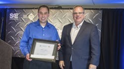 SAE/AEM Outstanding Young Engineer Award winner Stephen Lanahan, left, received award from SAE board of directors commercial vehicle vice president Landon Sproull of PACCAR Inc. at recent ceremonies.