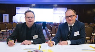 Haulotte CEO Tim Whiteman, left, and Stephane Hubert, chief sales officer for Haulotte, sign agreement at the Europa Hotel in Belfast, making Haulotte a sustaining member of IPAF.