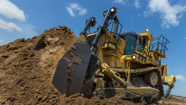 A Caterpillar D10T2 pushing dirt
