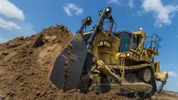A Caterpillar D10T2 pushing dirt
